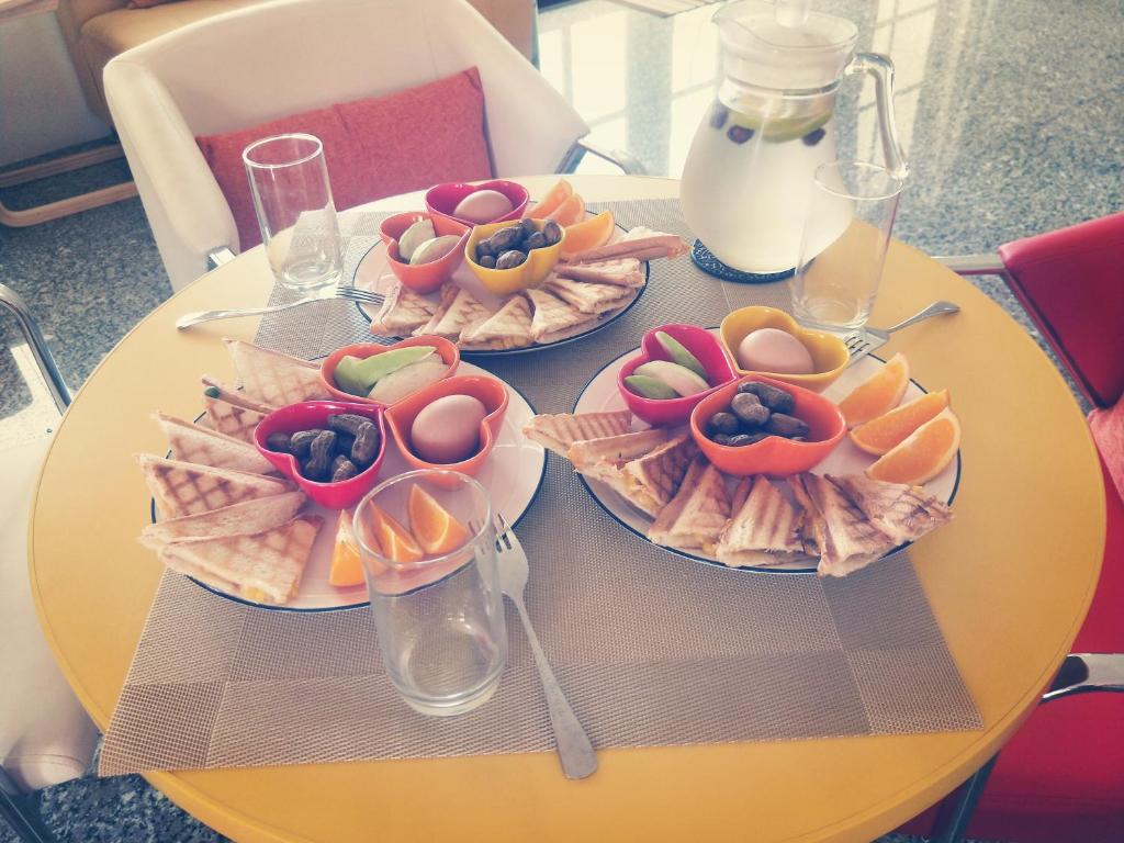 a yellow table with three plates of food on it at Full Moon Resort in Hengchun