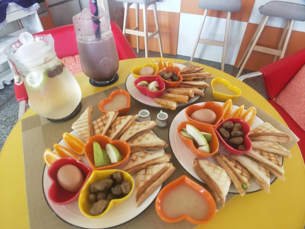 a yellow table with plates of food on it at Full Moon Resort in Hengchun