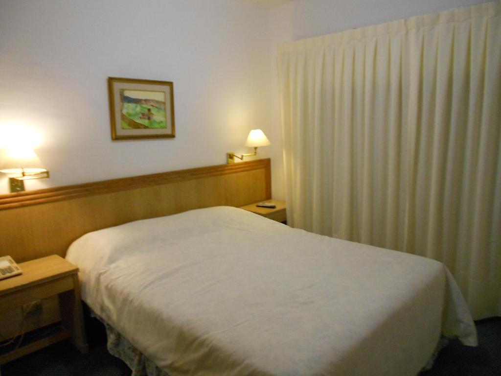 Postel nebo postele na pokoji v ubytování Tanger Hotel
