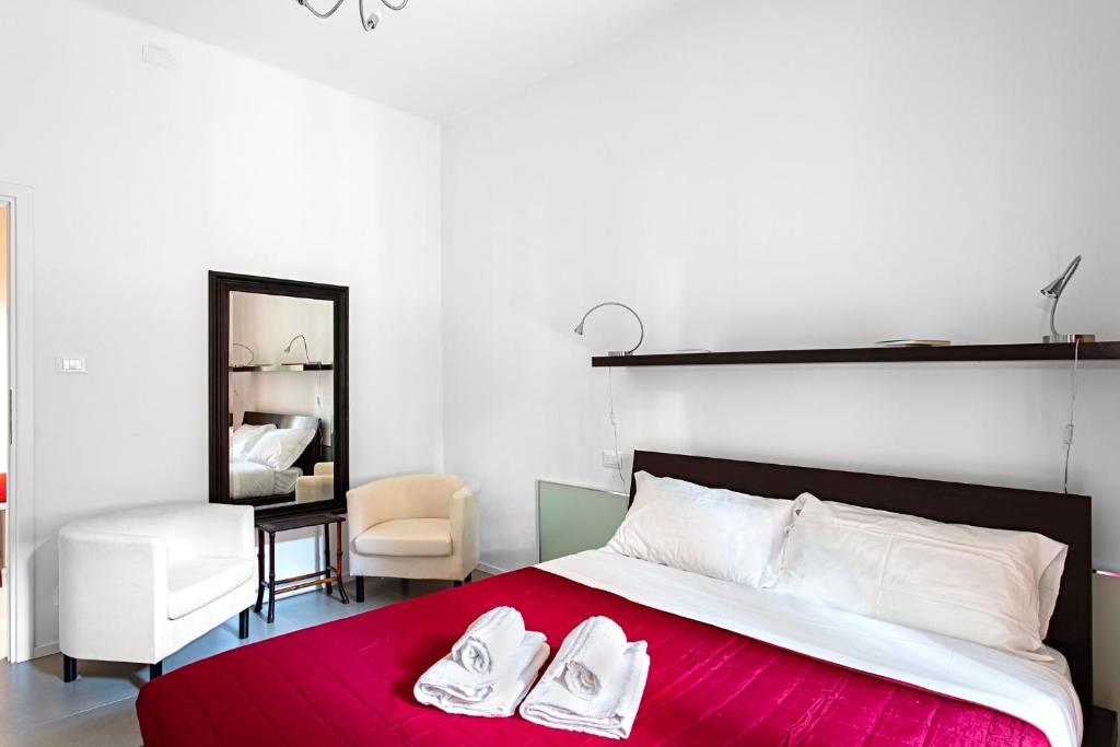 a bedroom with a bed with two white shoes on it at HouSmart Bondi 61 in Bologna