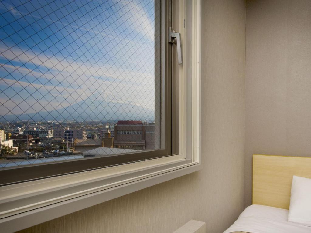 Voodi või voodid majutusasutuse Super Hotel Fuji Inter toas