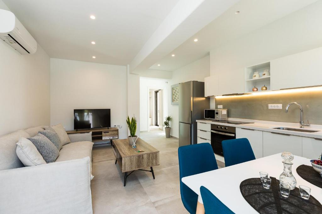 a kitchen and living room with a couch and a table at Naiades Apartment- Minthi/ 1 bedroom, beachfront in Plakias