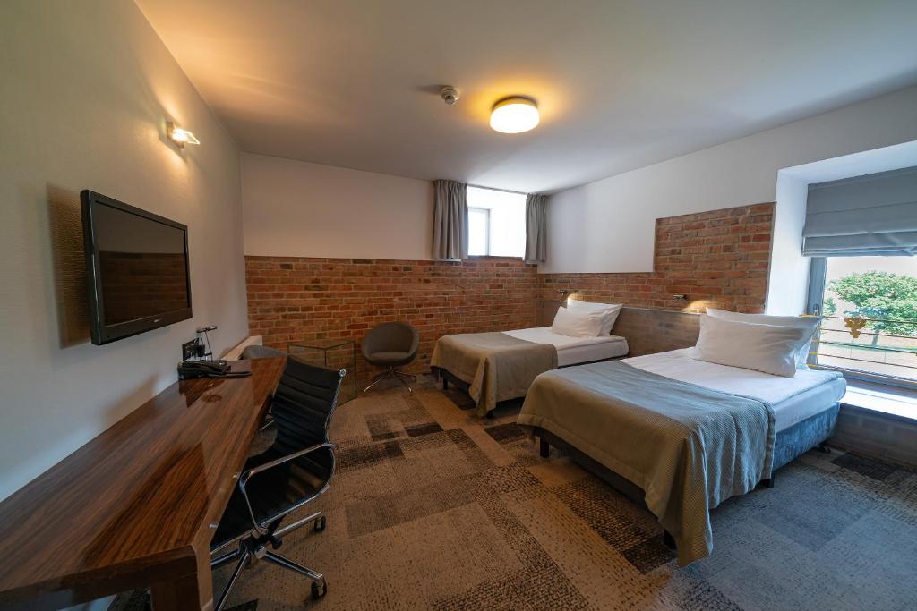 Televízia a/alebo spoločenská miestnosť v ubytovaní Q Hotel Grand Cru Gdańsk