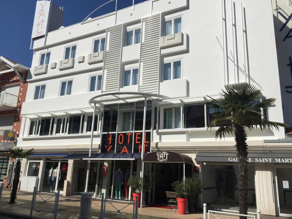 a white building with a sign that reads hotel at Yatt Hotel in Arcachon