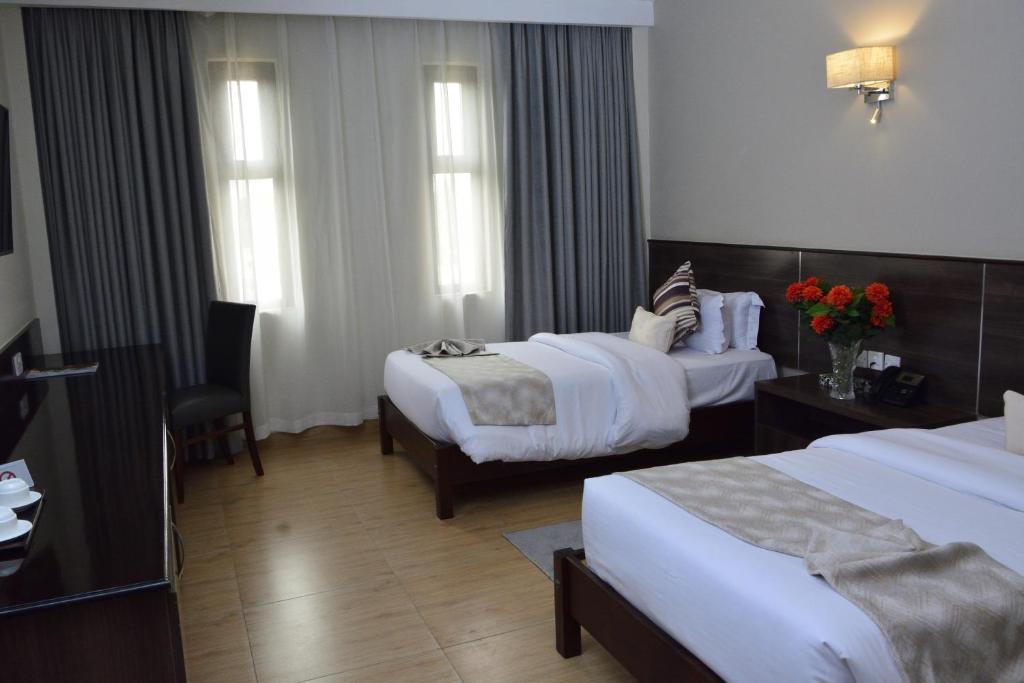 Postel nebo postele na pokoji v ubytování Razana Hotel
