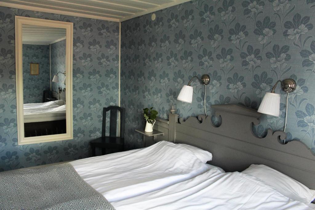 a bedroom with a bed and a mirror at STF Hostel Vilhelmina Kyrkstad in Vilhelmina