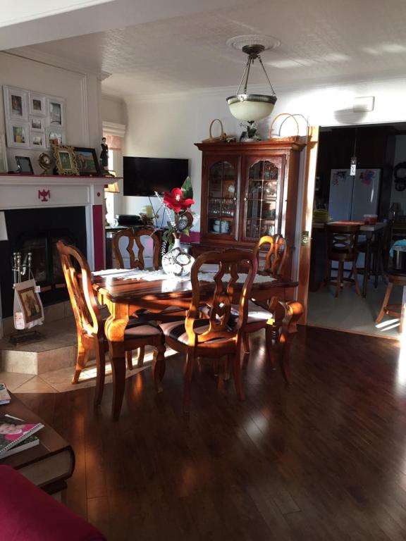 a dining room with a wooden table and chairs at gite des iles in Matane