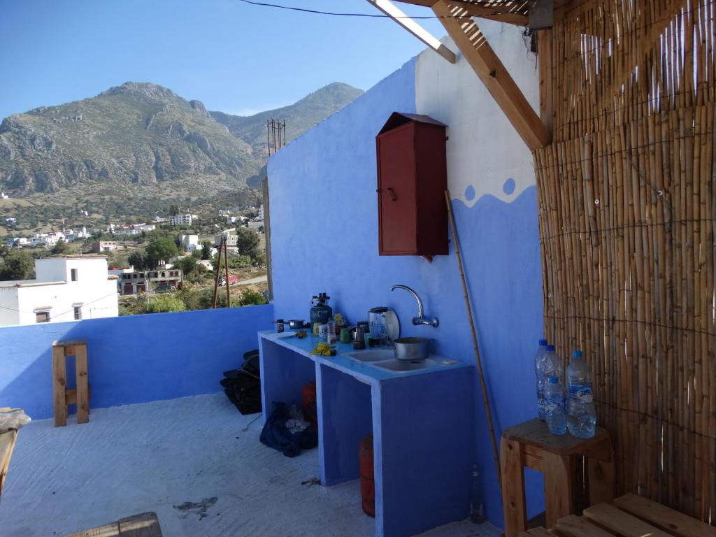 a blue room with a sink and a blue wall at AliBaba Apartment Hostel Bamboo Rooftop Room in Chefchaouen