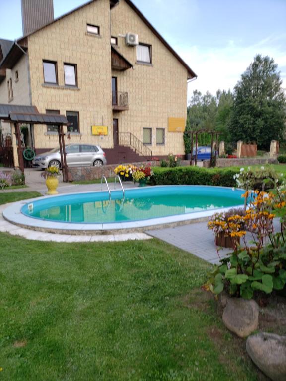 a swimming pool in the yard of a house at Cozy John's House in Vilnius