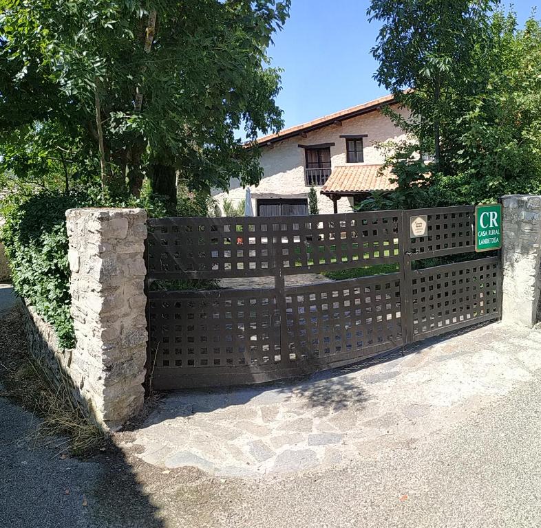 una valla de madera frente a una casa en Arkamo Atea, en Cárcamo