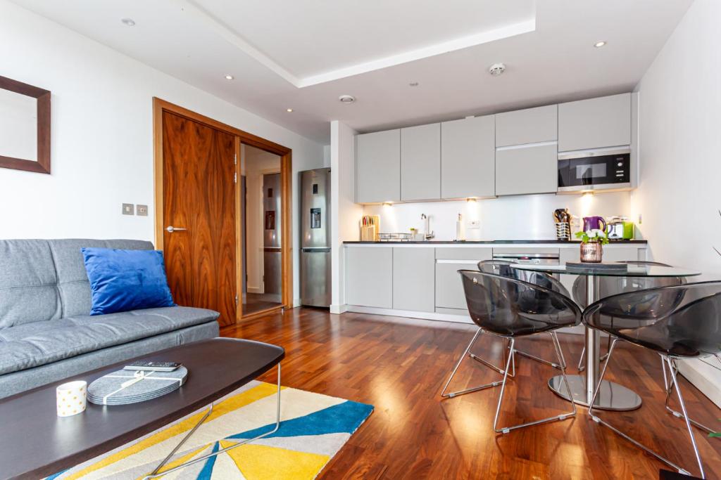 a living room with a couch and a table at Esquire Media City in Manchester