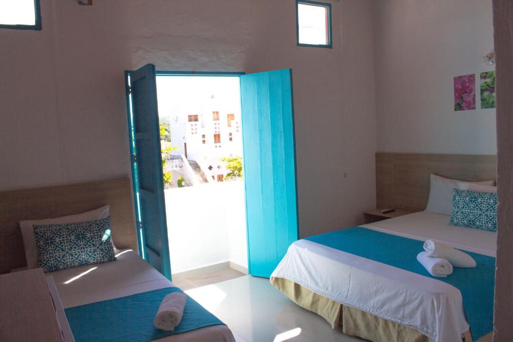 Postel nebo postele na pokoji v ubytování Hotel Aldea Plaza