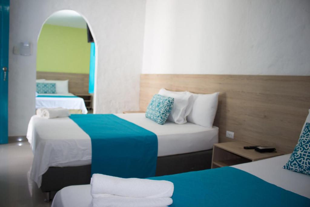 Postel nebo postele na pokoji v ubytování Hotel Aldea Plaza