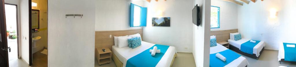 Postel nebo postele na pokoji v ubytování Hotel Aldea Plaza