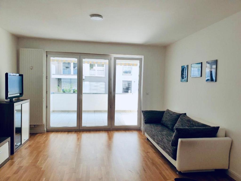 a living room with a couch and a television at Apartments am Wall in Bremen