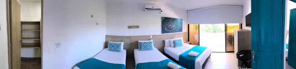 Postel nebo postele na pokoji v ubytování Hotel Aldea Plaza