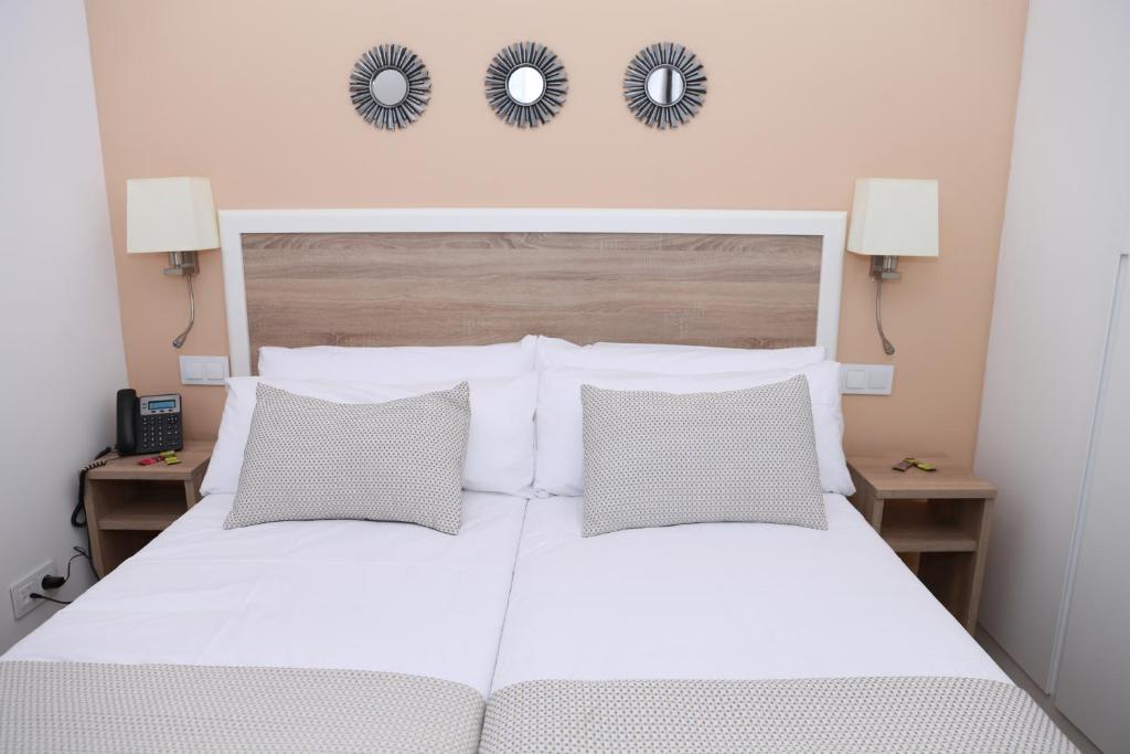 A bed or beds in a room at New Point Opera