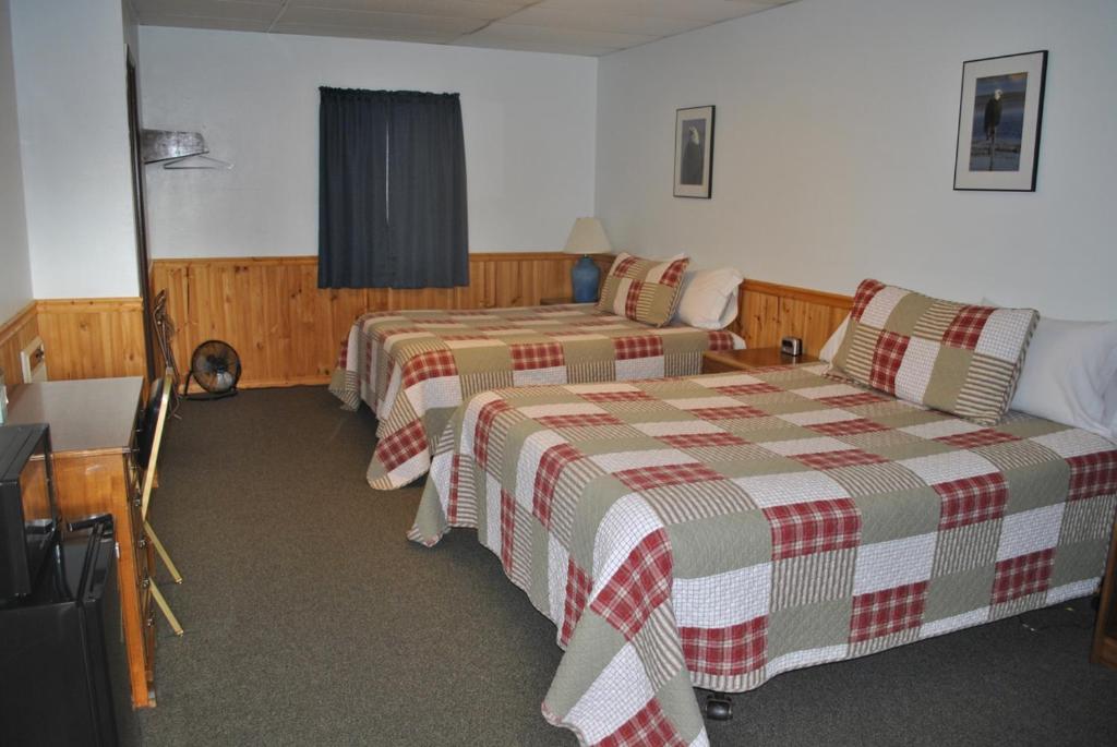 Postel nebo postele na pokoji v ubytování Aspen Inn