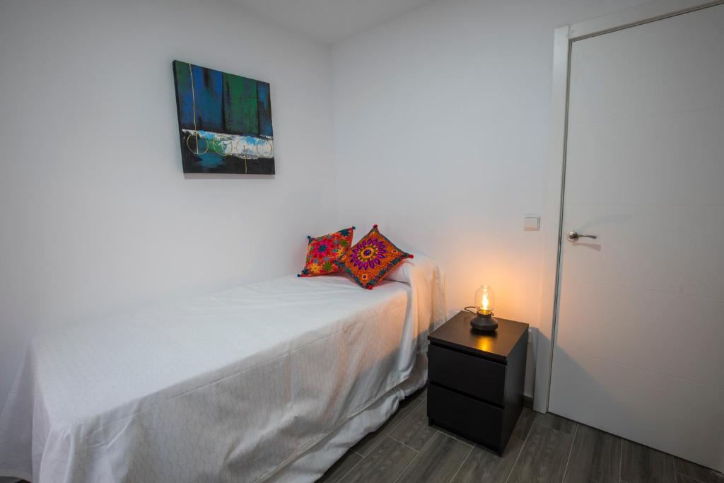 Postel nebo postele na pokoji v ubytování Apartamentos Cáceres Turístico