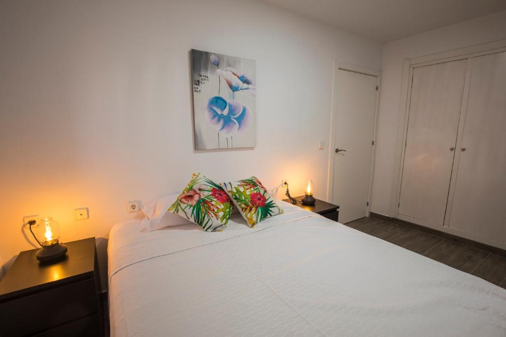 Postel nebo postele na pokoji v ubytování Apartamentos Cáceres Turístico