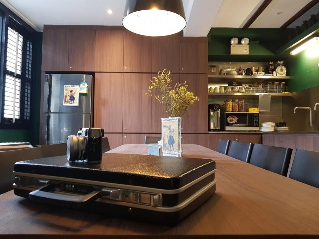 a suitcase sitting on top of a table in a kitchen at Wink at Mosque Street in Singapore