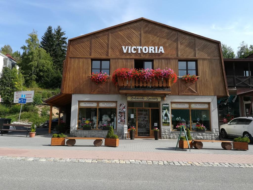 a building with flowers on the front of it at Apartment Victoria in Harrachov