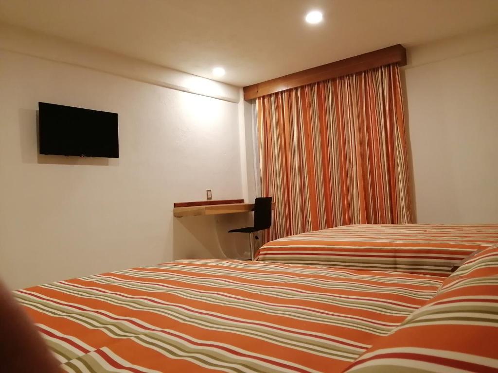 TV a/nebo společenská místnost v ubytování Misol-Ha Hotel Mérida
