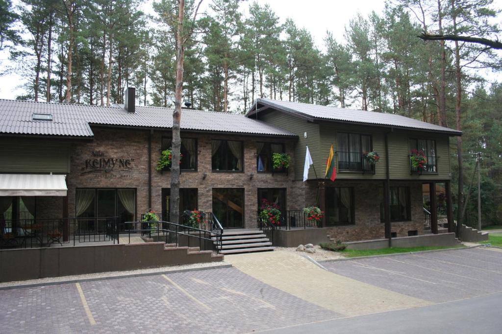 a building with flowers in front of it at Vila Kelmyne in Molėtai