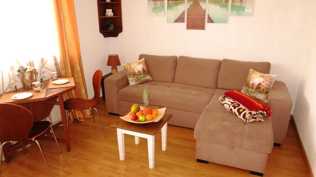 a living room with a couch and a table with a bowl of fruit at Holiday home close to golden mile in Playa de las Americas