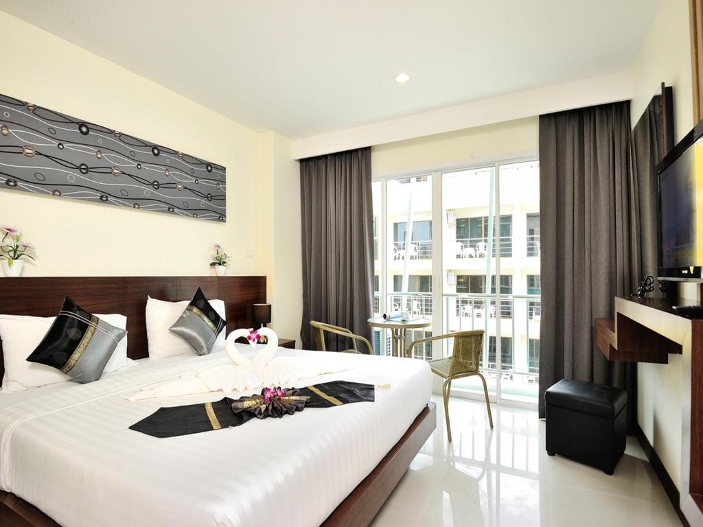 Postel nebo postele na pokoji v ubytování Pimrada Hotel
