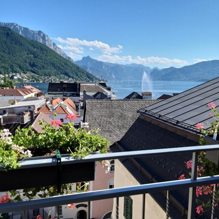 a view of the lake from the balcony of a building at Marktplatz Traunsee LAKE View in Gmunden