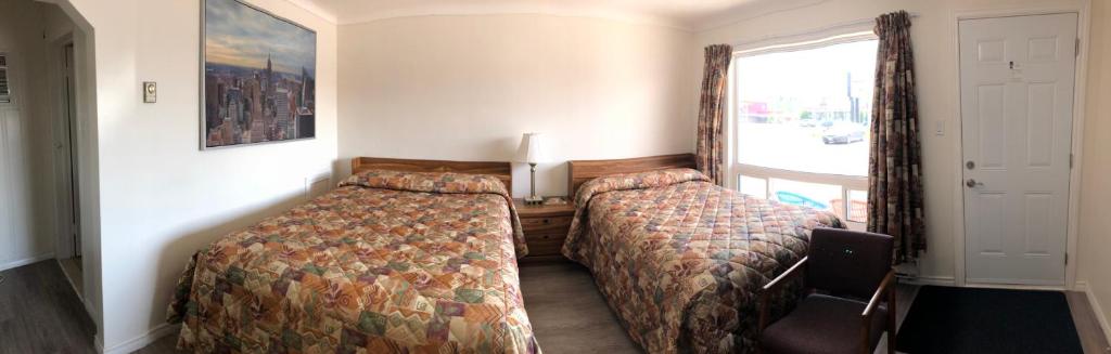 Postel nebo postele na pokoji v ubytování Century Motel