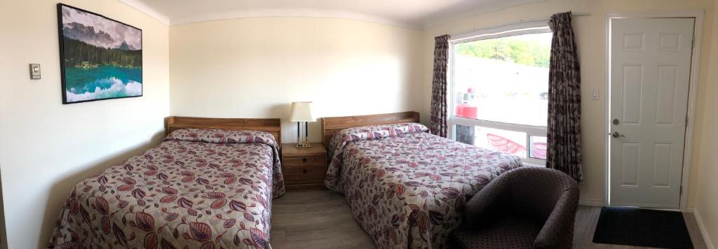 Postel nebo postele na pokoji v ubytování Century Motel