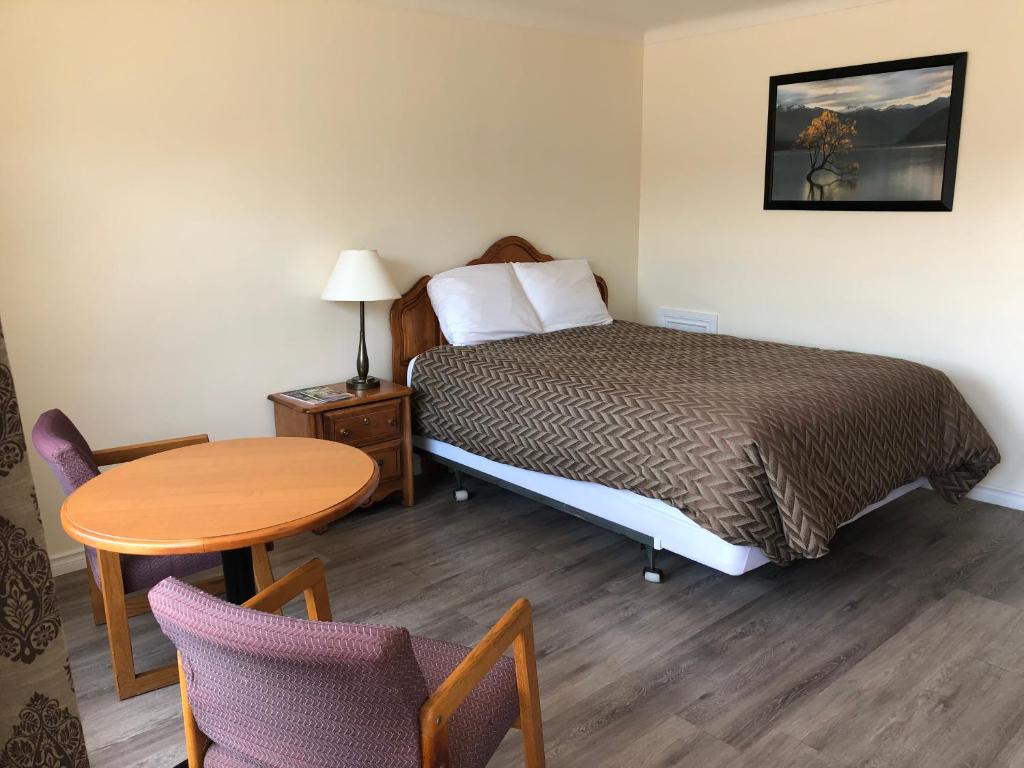 Postel nebo postele na pokoji v ubytování Century Motel