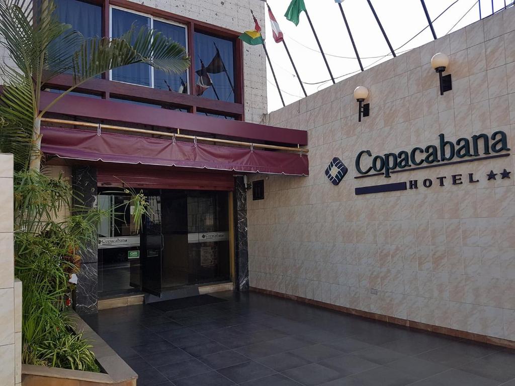 a hotel with a sign on the side of a building at Copacabana Hotel in Tacna