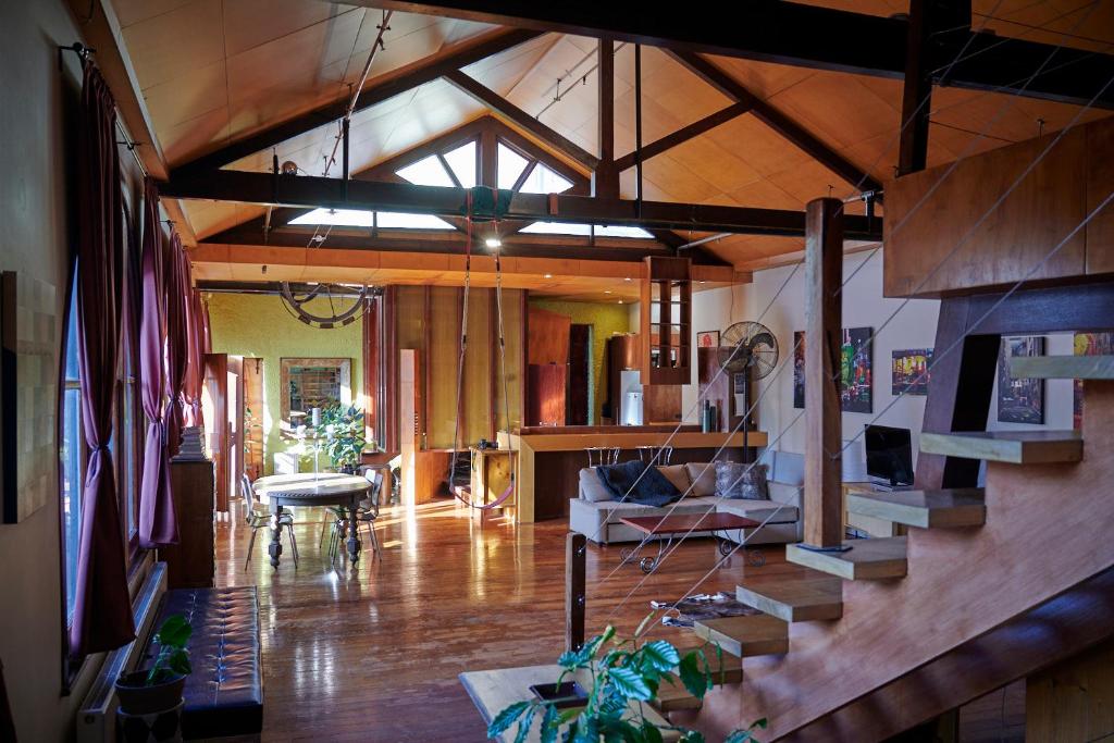 een woonkamer met een trap in een huis bij Central City Warehouse Apartment in Melbourne
