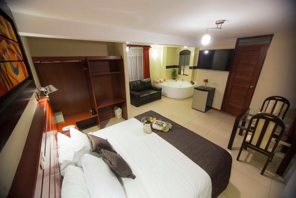 1 dormitorio con 1 cama grande y baño en Hotel La Casona Del Olivo Arequipa, en Arequipa