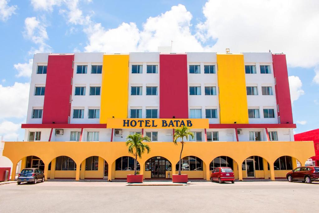 a hotel building with red yellow and white at Hotel Batab in Cancún