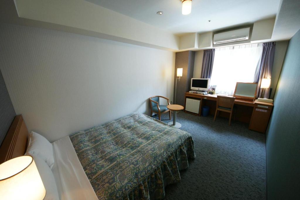 Postel nebo postele na pokoji v ubytování Hotel Landmark Nagoya