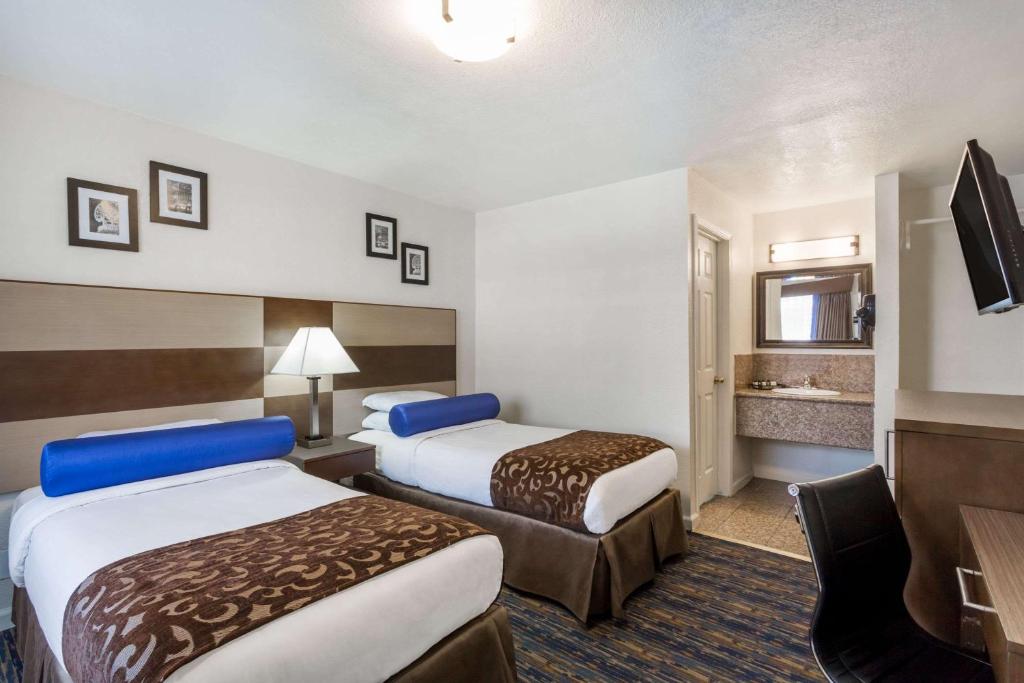 a hotel room with two beds and a television at Howard Johnson By Wyndham Berkeley in Berkeley