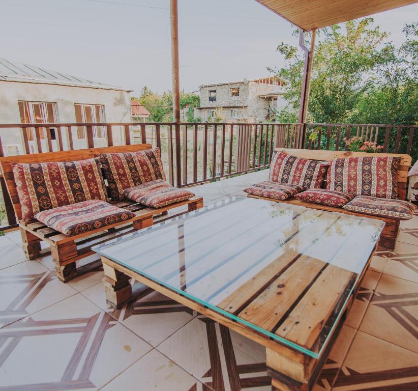 a patio with two couches and a glass table at Telavi Tel Aviv in Tʼelavi