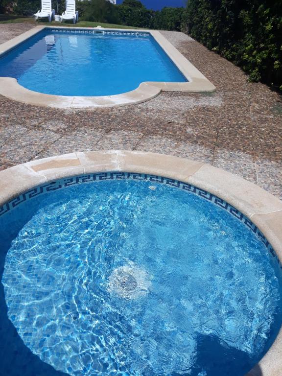 a large pool with blue water in a yard at Rocamar 2 in Cala Morell