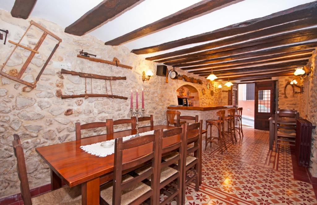uma sala de jantar com uma mesa de madeira e cadeiras em Casa La Torre em Torremanzanas