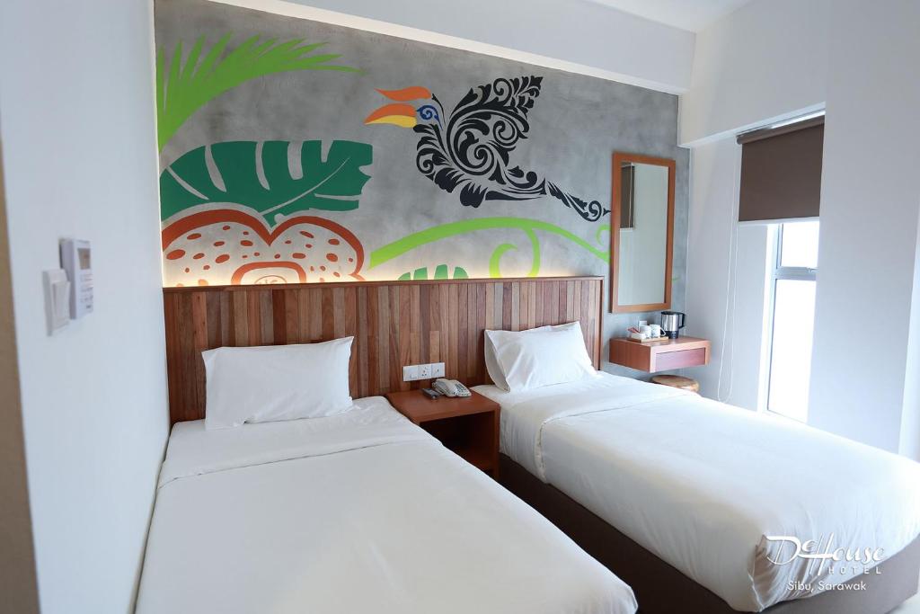 Postel nebo postele na pokoji v ubytování De House Hotel