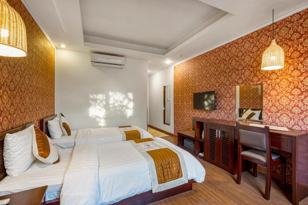 Postel nebo postele na pokoji v ubytování First Eden Hotel - Hang Bun