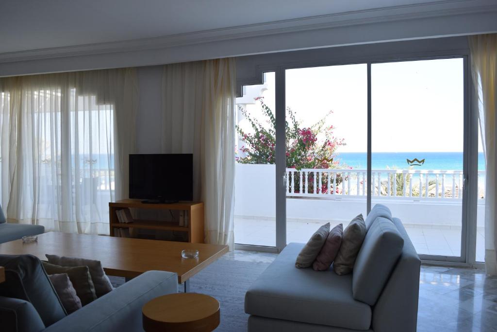 a living room with a couch and a table at OCEANA Hotel & Spa in Hammamet