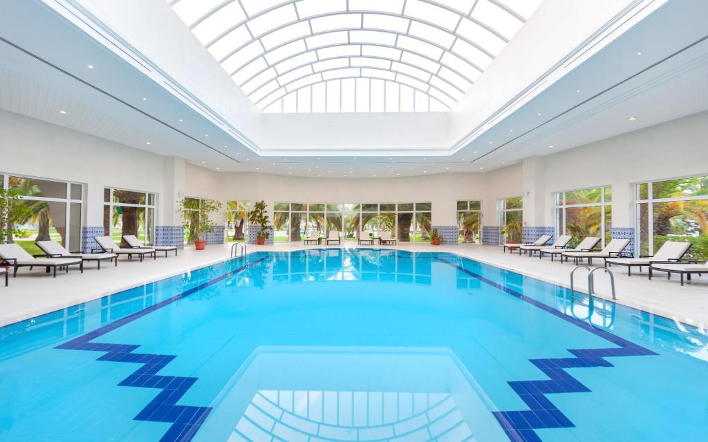 a swimming pool with a skylight in a hotel at OCEANA Hotel & Spa in Hammamet