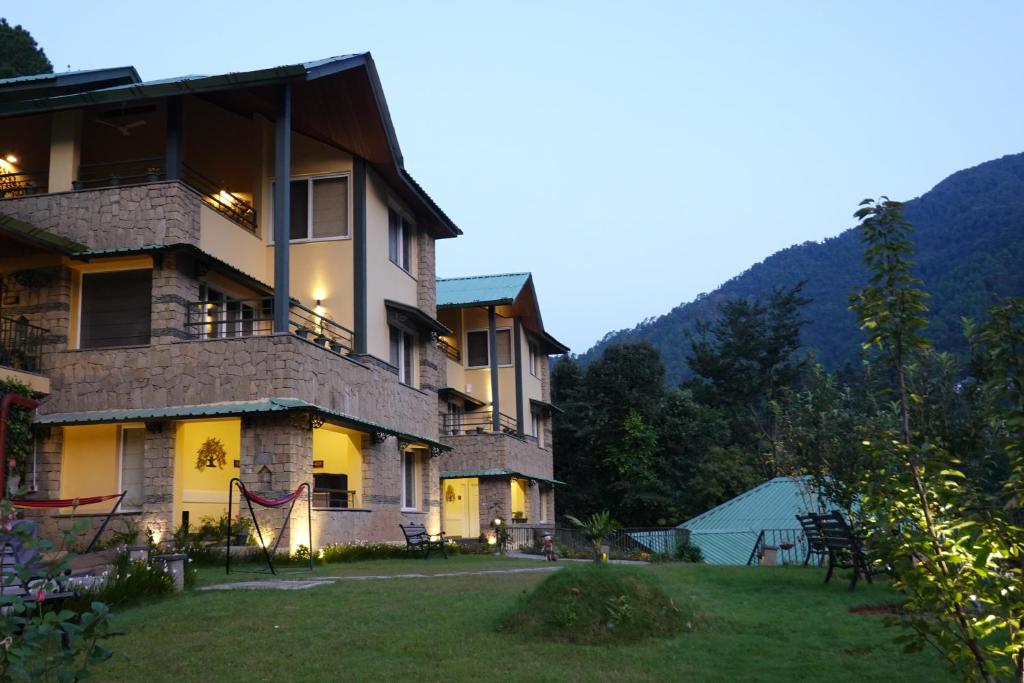 a large building with a lawn in front of it at Araiya Palampur in Pālampur