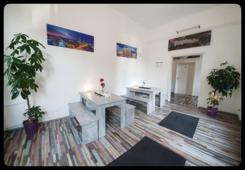 a room with two tables and two potted plants at Hostel 199 in Berlin