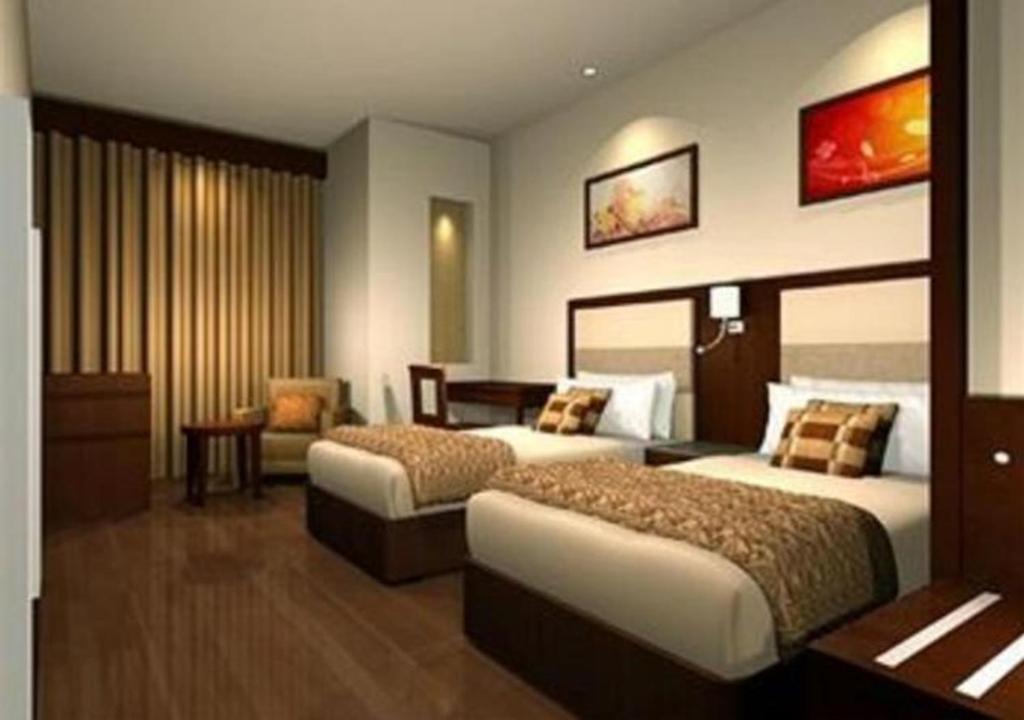 Postel nebo postele na pokoji v ubytování Hotel DS Clarks Inn Gurgaon